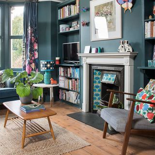 blue living room with fireplace and shelves