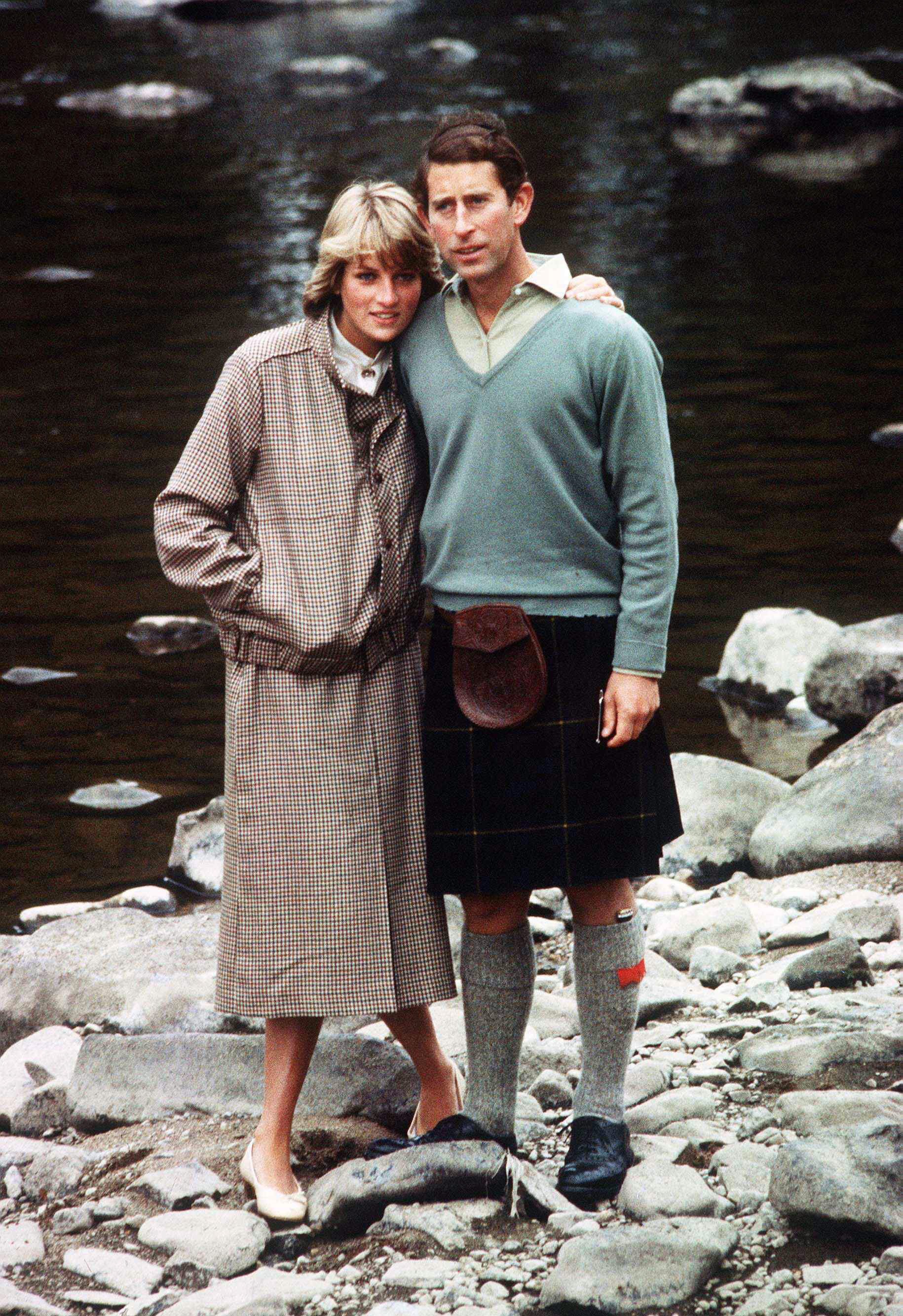 Princess Diana and Prince Charles posing on rocks by the river at Balmoral Castle