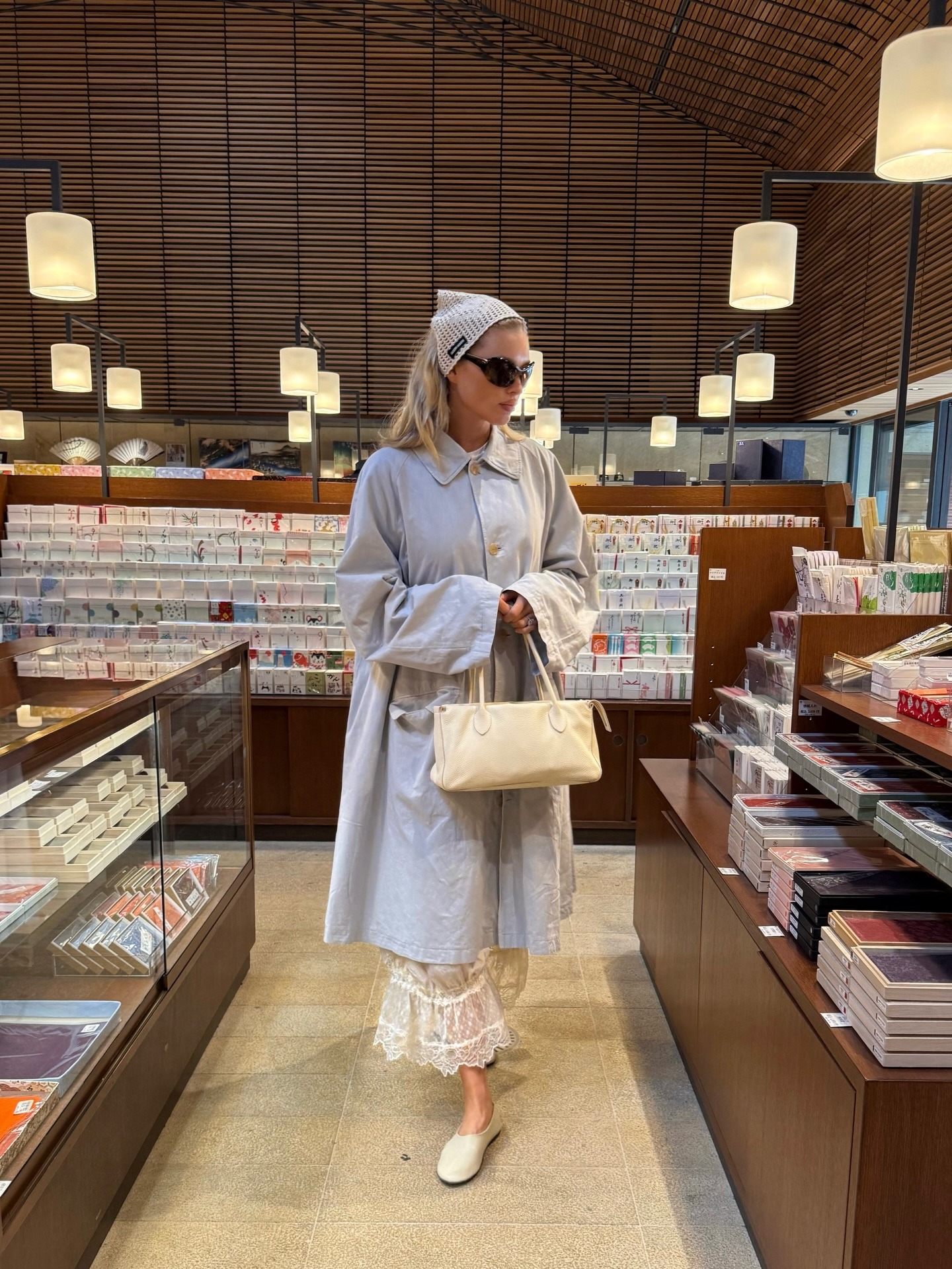 Elsa Hosk wearing petticoat pants with a trench coat and flats in Tokyo