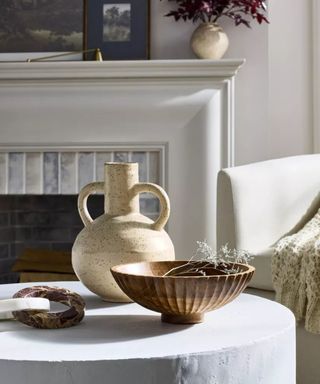 Handled vase on coffee table with wooden bowl