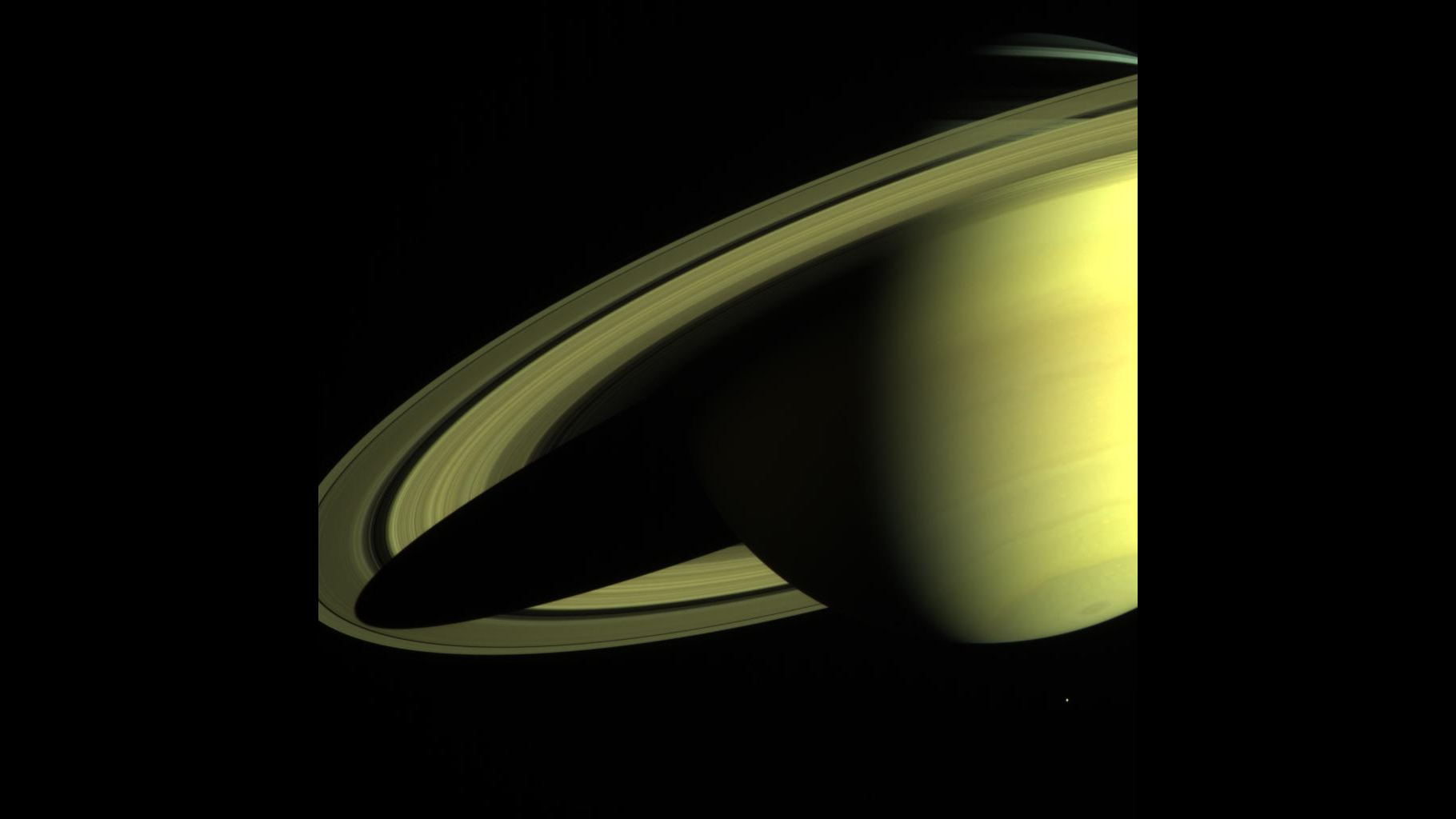 Saturn imaged by Cassini-Huygens shows the large ring system in partial shadow.