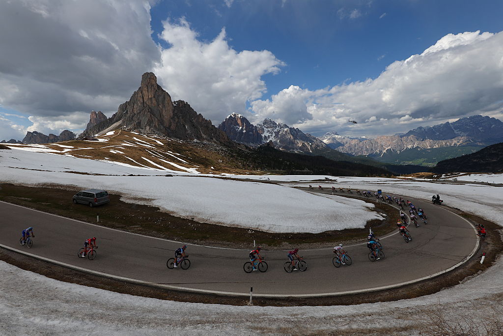 The pack of riders cycles down the Passo Giau pass in the Dolomites mountains during the nineteenth stage of the Giro d'Italia 2023 