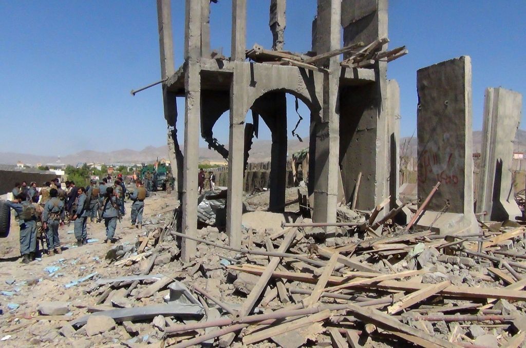 Afghan policeman at site of suicide bombing.