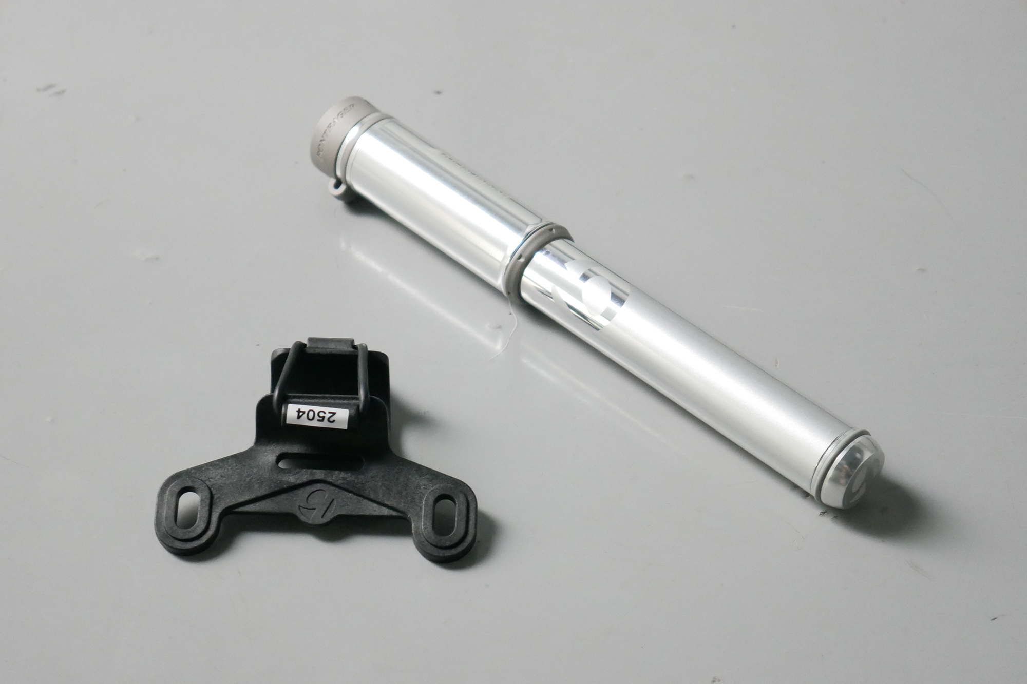 Best bike mini pumps group test 2026 - Bontrager Air Support in silver set to a grey background with its bottle cage mount
