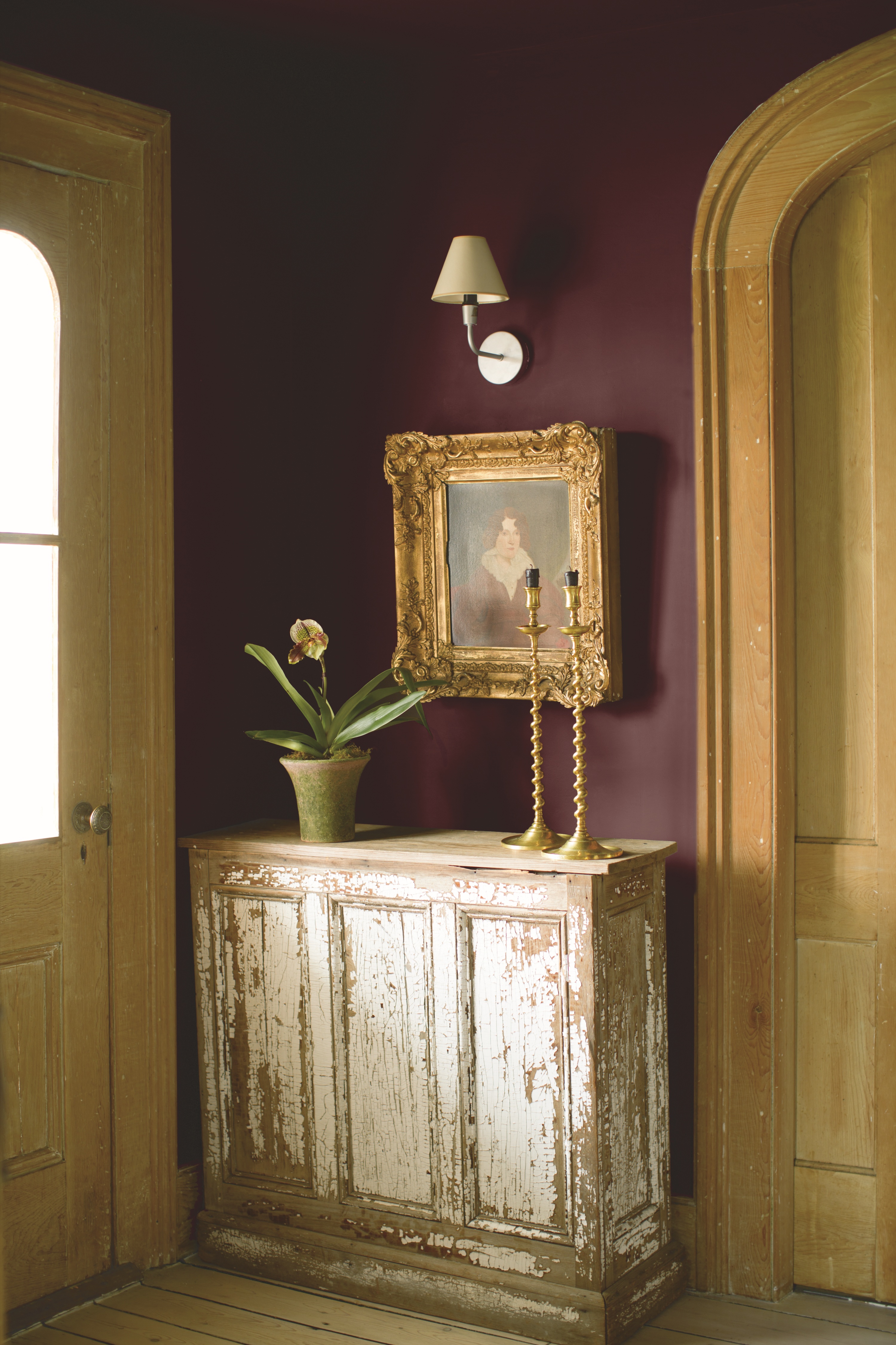burgundy hallway with rustic cream console by Benjamin Moore