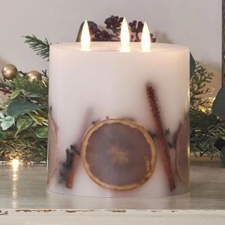 A 3-wick flameless winter candle with decorative in-laid fruit.
