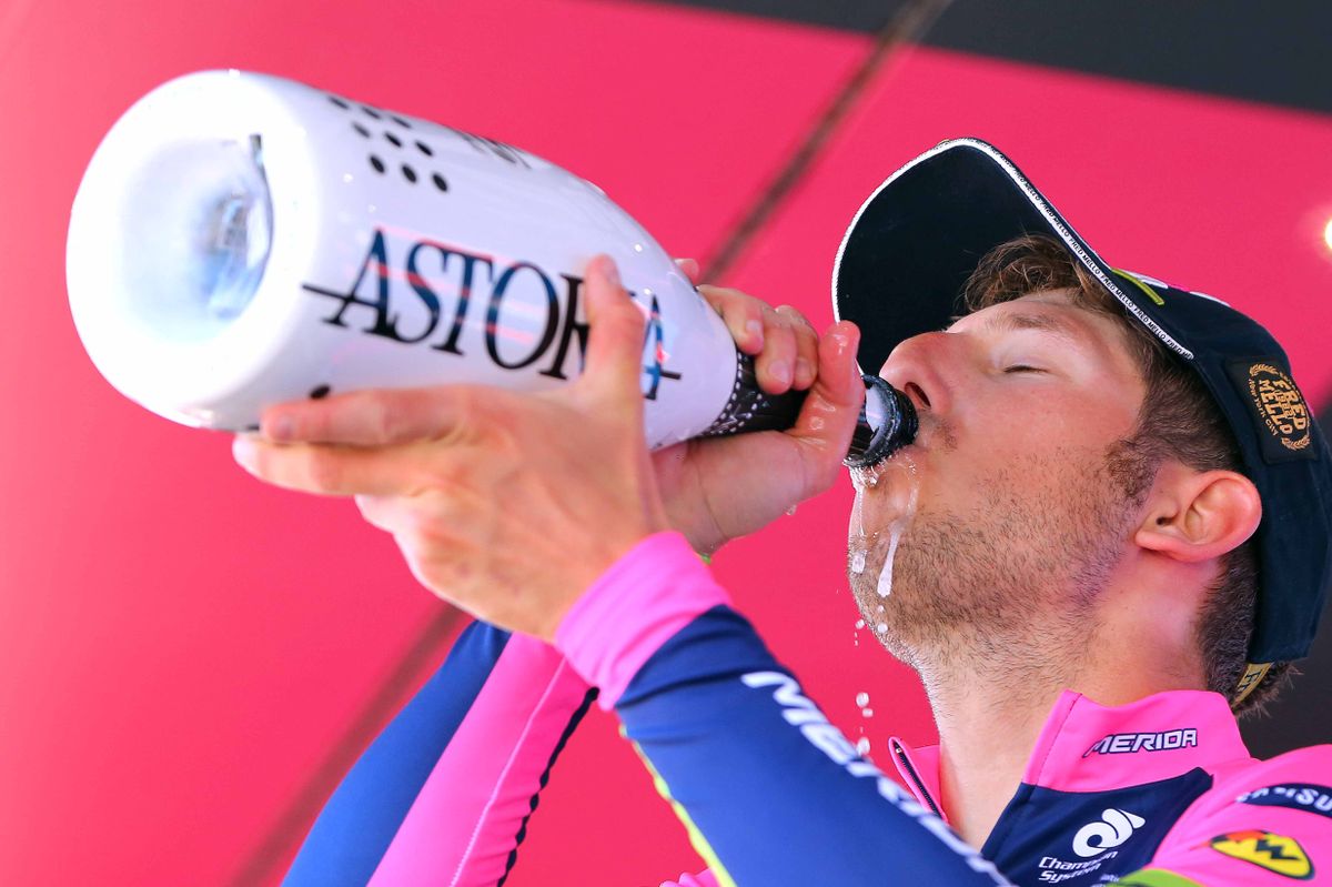 Sacha Modolo has a big swig from the bottle of prosecco