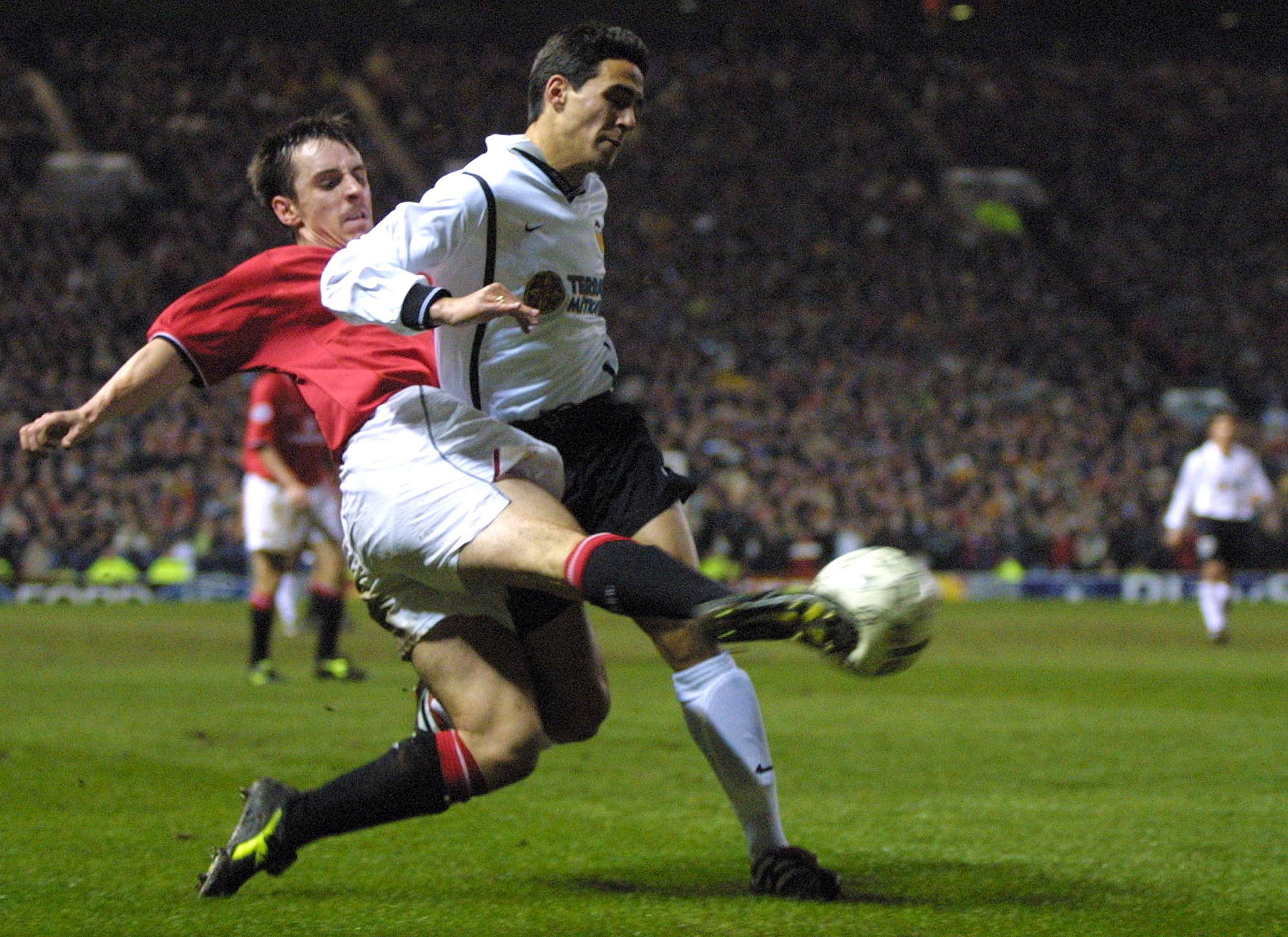 Manchester United's Gary Neville (left) fights for the ball with Valencia's Vicente in a Champions League game in February 2001.