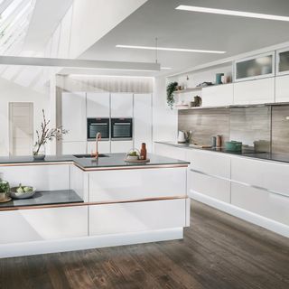 kitchen with wooden flooring and white wall and white cabinets