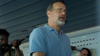 A Somali pirate points a gun at Captain Phillips (Tom Hanks) in Captain Phillips. 