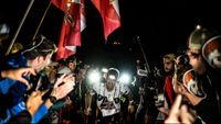 French athlete Mathieu Blanchard competes surrounded by supporters during the 20th edition of The Ultra Trail du Mont Blanc