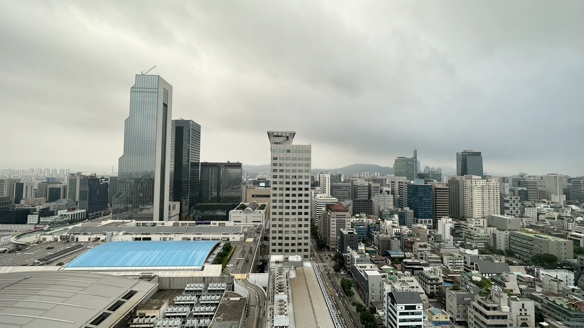View of cloudy Seoul skyscape with mountain in distance