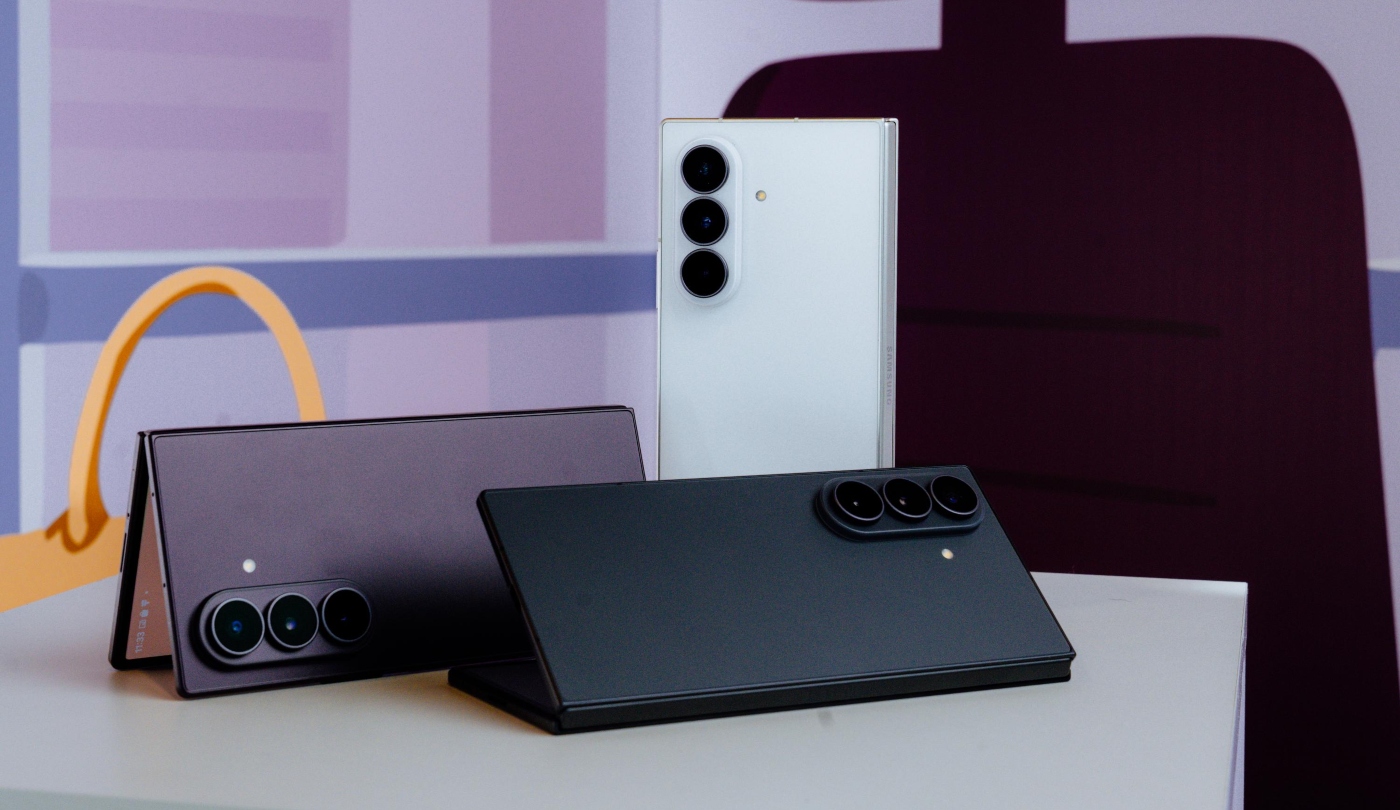 Three different coloured Samsung Galaxy Z Fold Ultra phones on a table