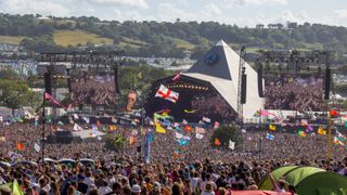 Shot from Day Two of crowds watching a performance on the Pyramid Stage during Glastonbury 2022