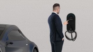 A man stands at an LG EV Charger. 