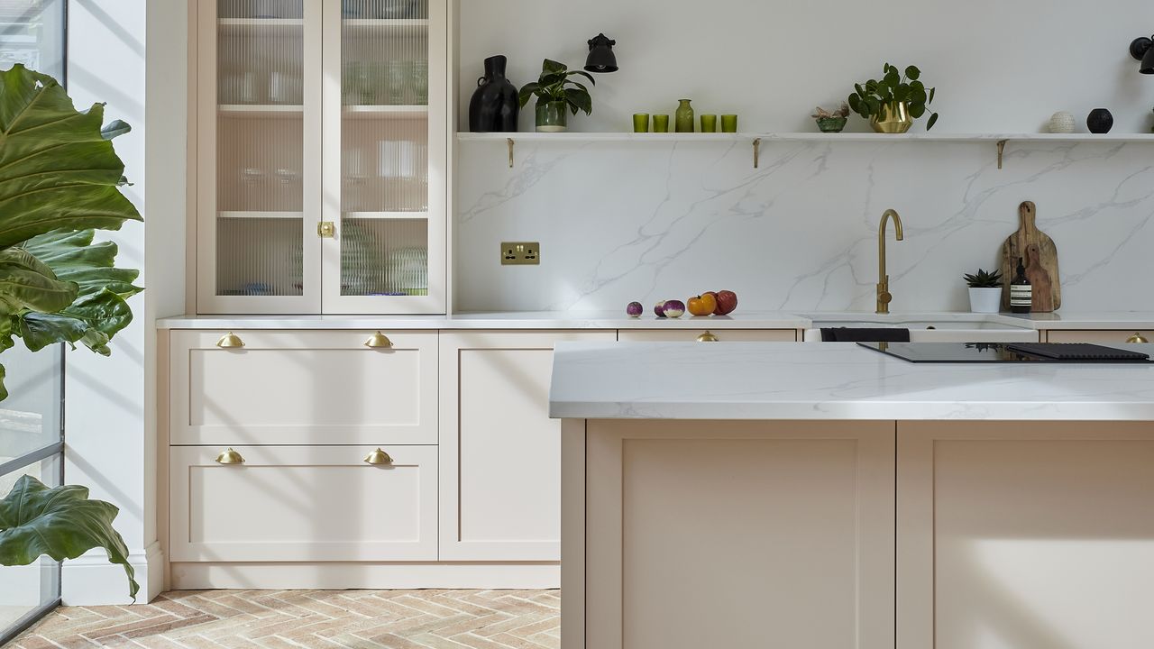 Pale pink shaker kitchen with teracotta tiles