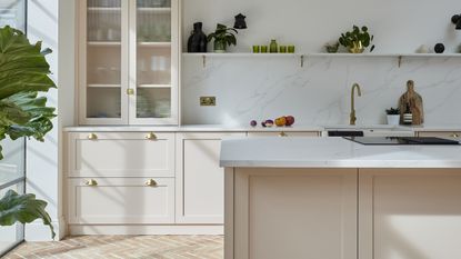Pale pink shaker kitchen with terracotta tiles