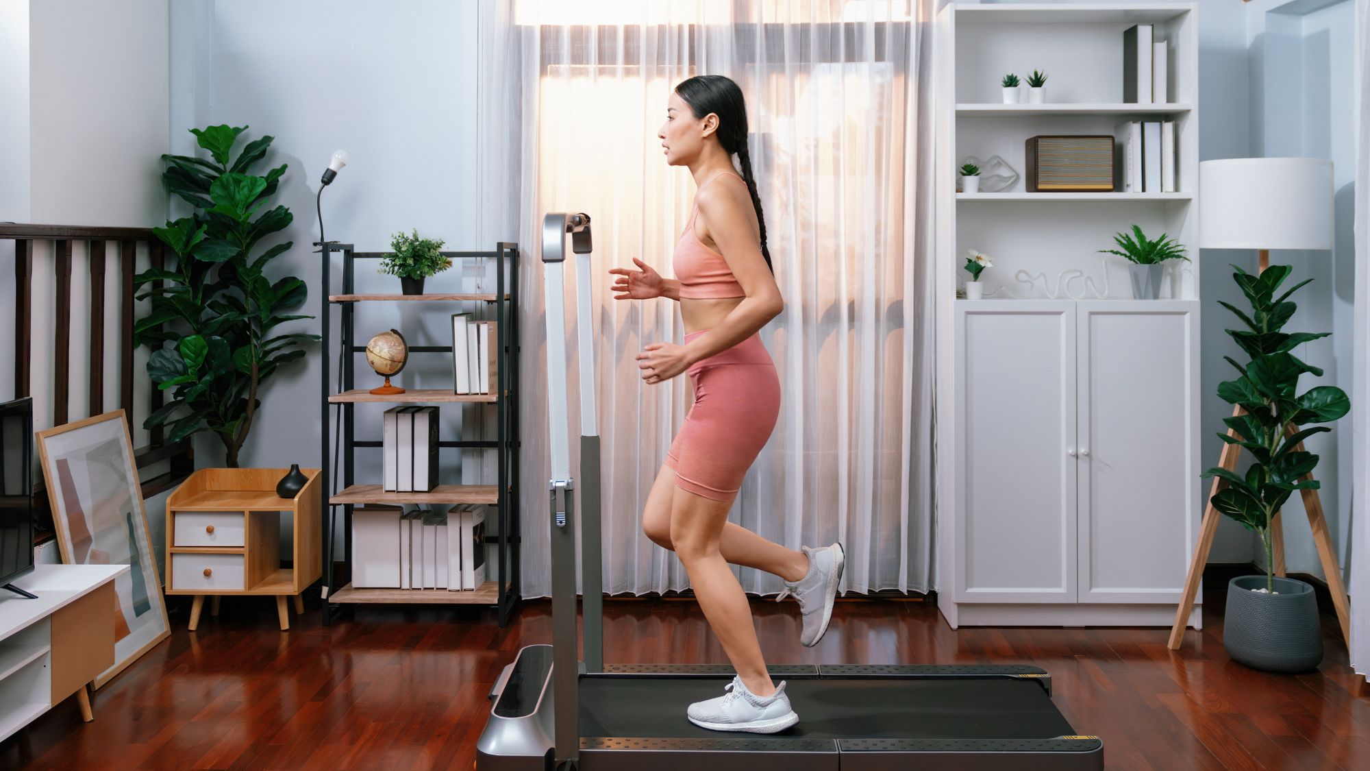 A woman doing one of the best walking pad workouts at home