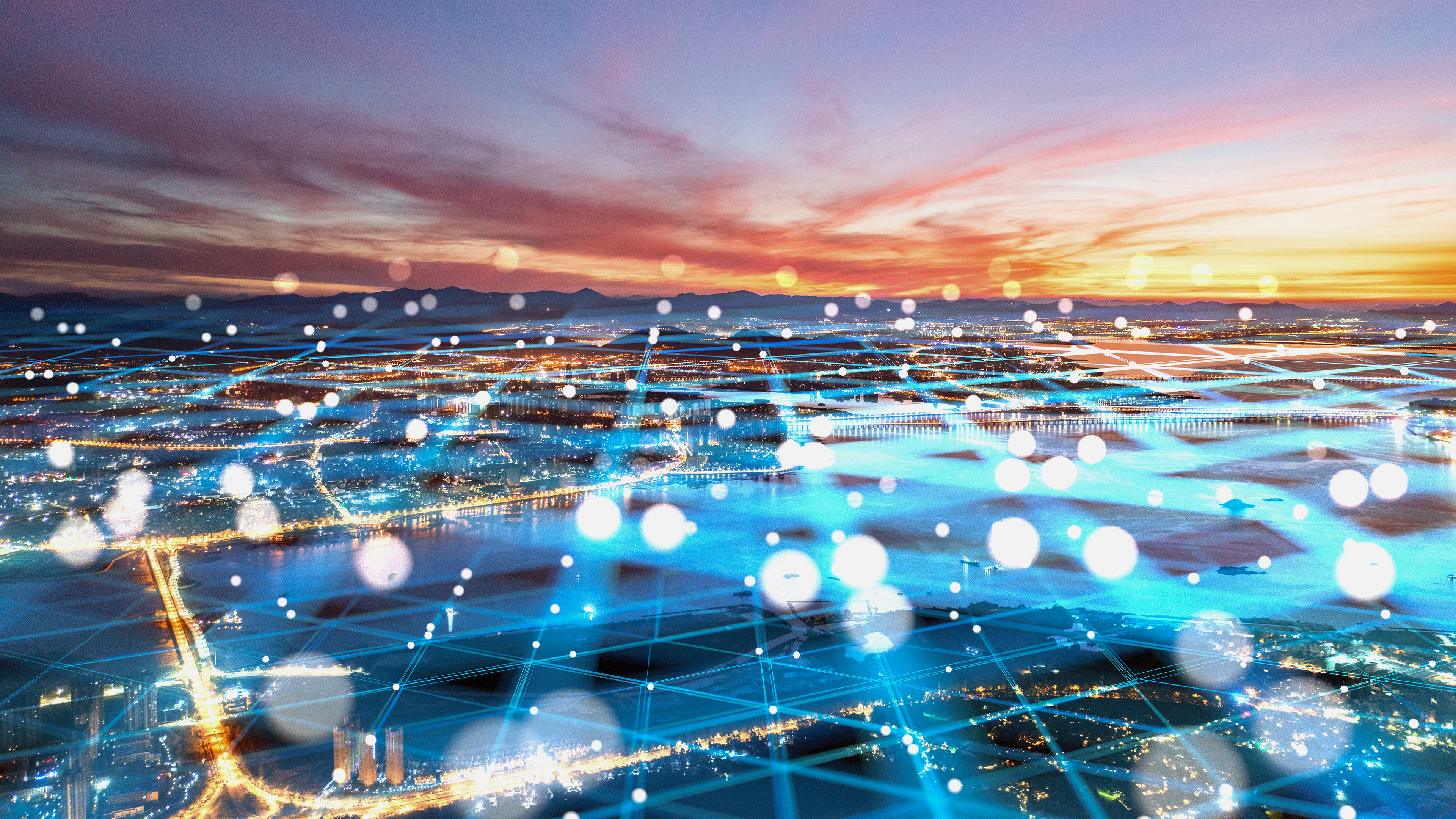 A digital grid criss-crossing the lights of a city below