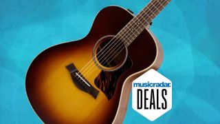 A Taylor AD12e-SB acoustic electric guitar against a textured blue background