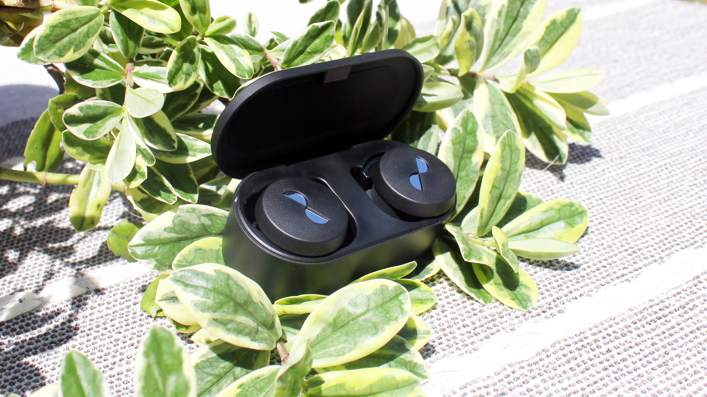 the nuratrue wireless earbuds in their charging case