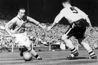 Blackpool's Stanley Matthews takes on Bolton Wanderers' Malcolm Barrass in the 1953 FA Cup final