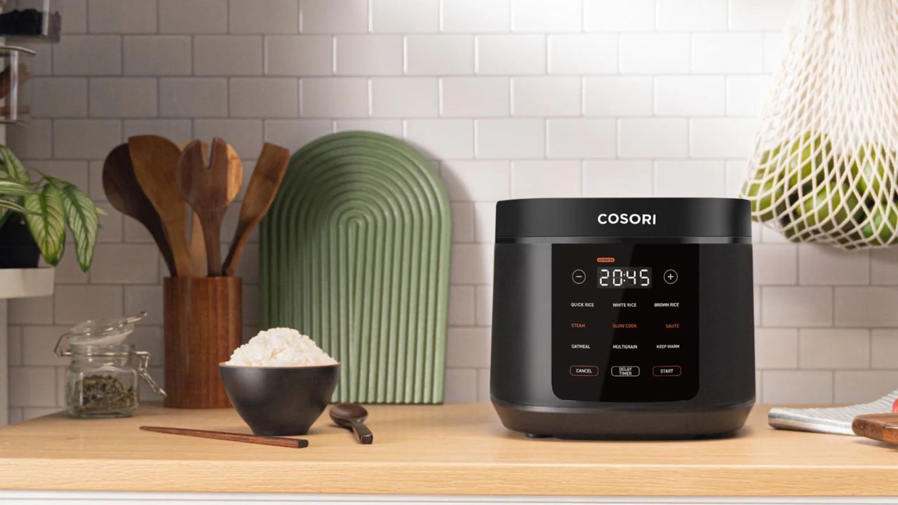 A Cosori 5-Quart Rice Cooker on a countertop with a bowl of white rice