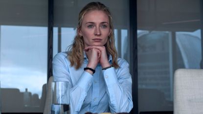 Sophie Turner clasps her hand under her chin