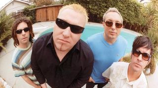 A photo of the band members of Smash Mouth all close up to the camera