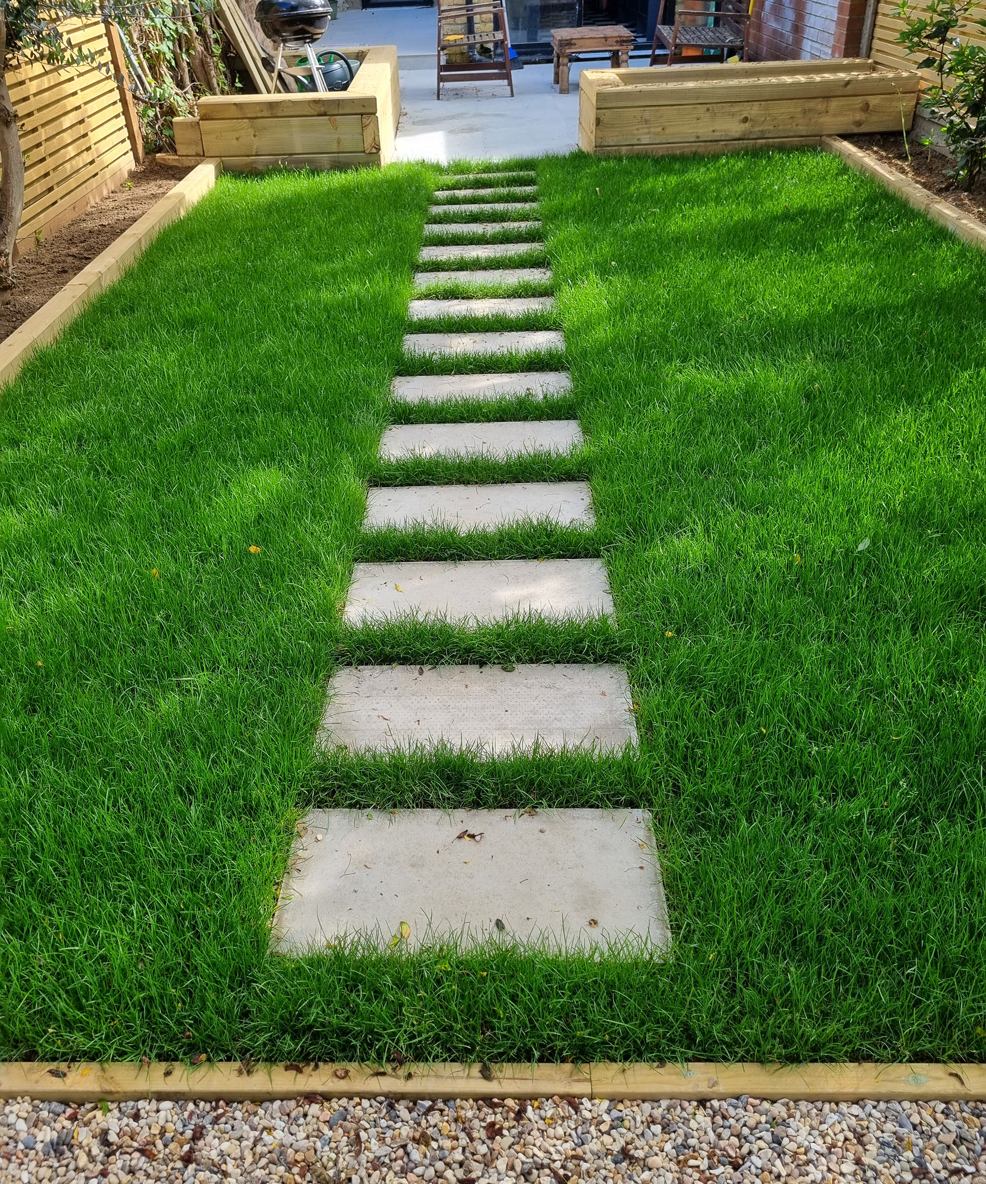 A stone path with rectangular slabs set into a lawn at 10cm intervals