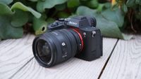 Sony A7 V camera with lens attached on a wooden surface