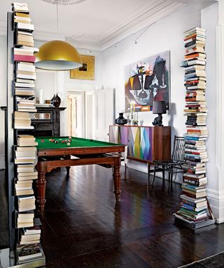 stoe room with pool table and books