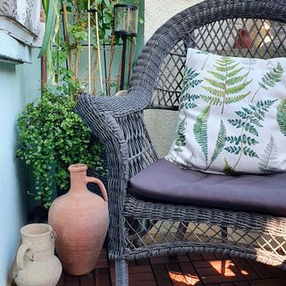 balcony garden with click flooring and grey chair