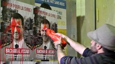 Syrian activists splash paint on President Assad's election posters