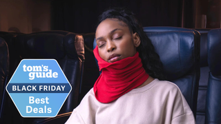 Woman wearing Trtl neck pillow with Tom's Guide best deals badge