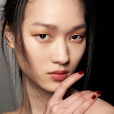 model posing backstage wearing dark red nail polish