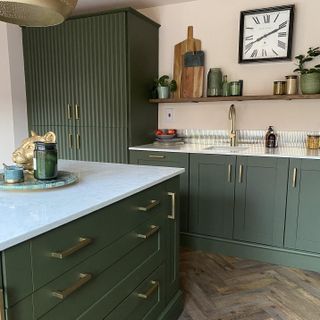 green kitchen cabinets and island unit