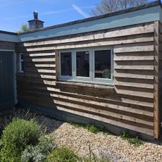 timber cladding on garage with gravel path and garden bed