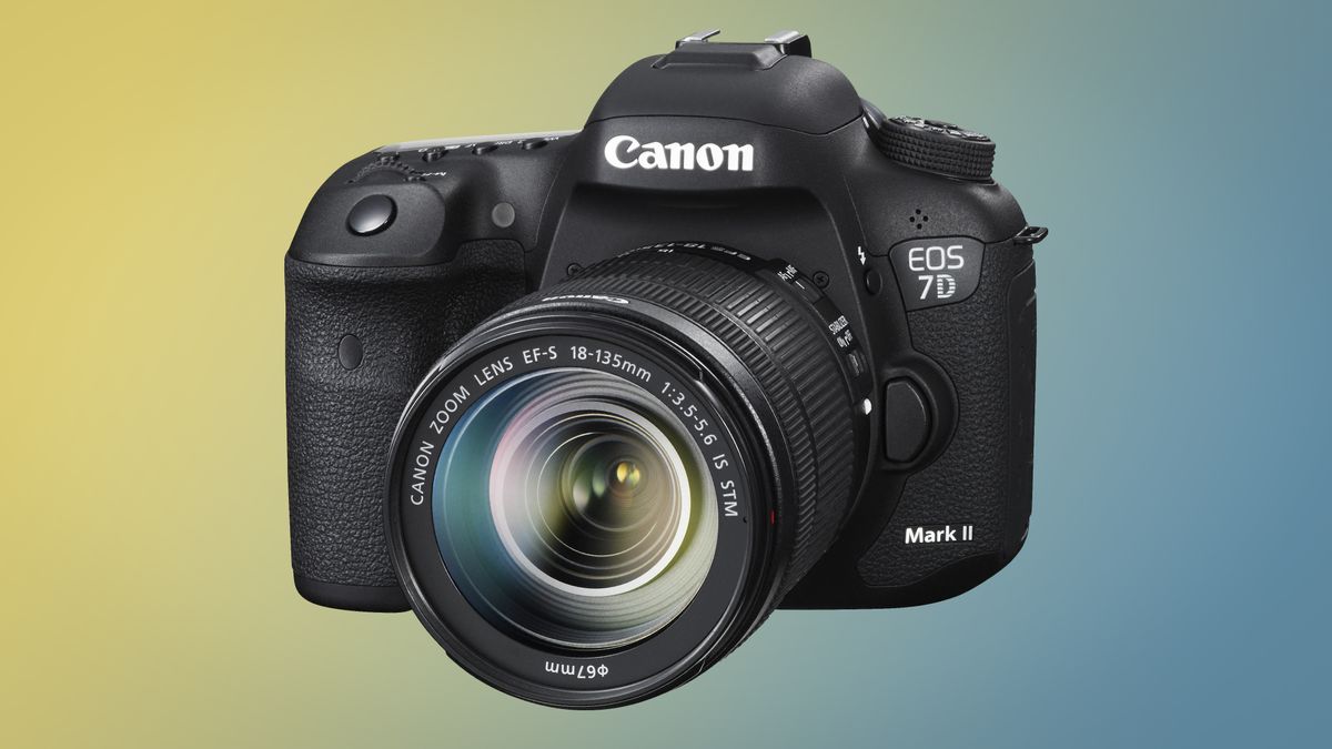 Canon EOS 7D Mark II camera with 18-135mm kit lens against a yellow-and-blue background