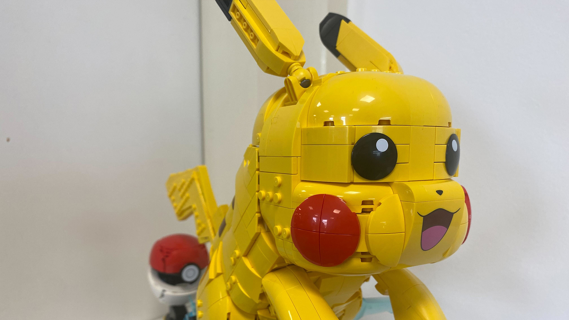 Lego Pikachu and Poke Ball set against a white background