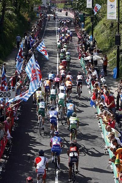 Flags fly over the peloton on the Cauberg