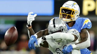 Los Angeles Chargers defensive back Nasir Adderley #24 breaks up the pass intended for Las Vegas Raiders wide receiver Henry Ruggs