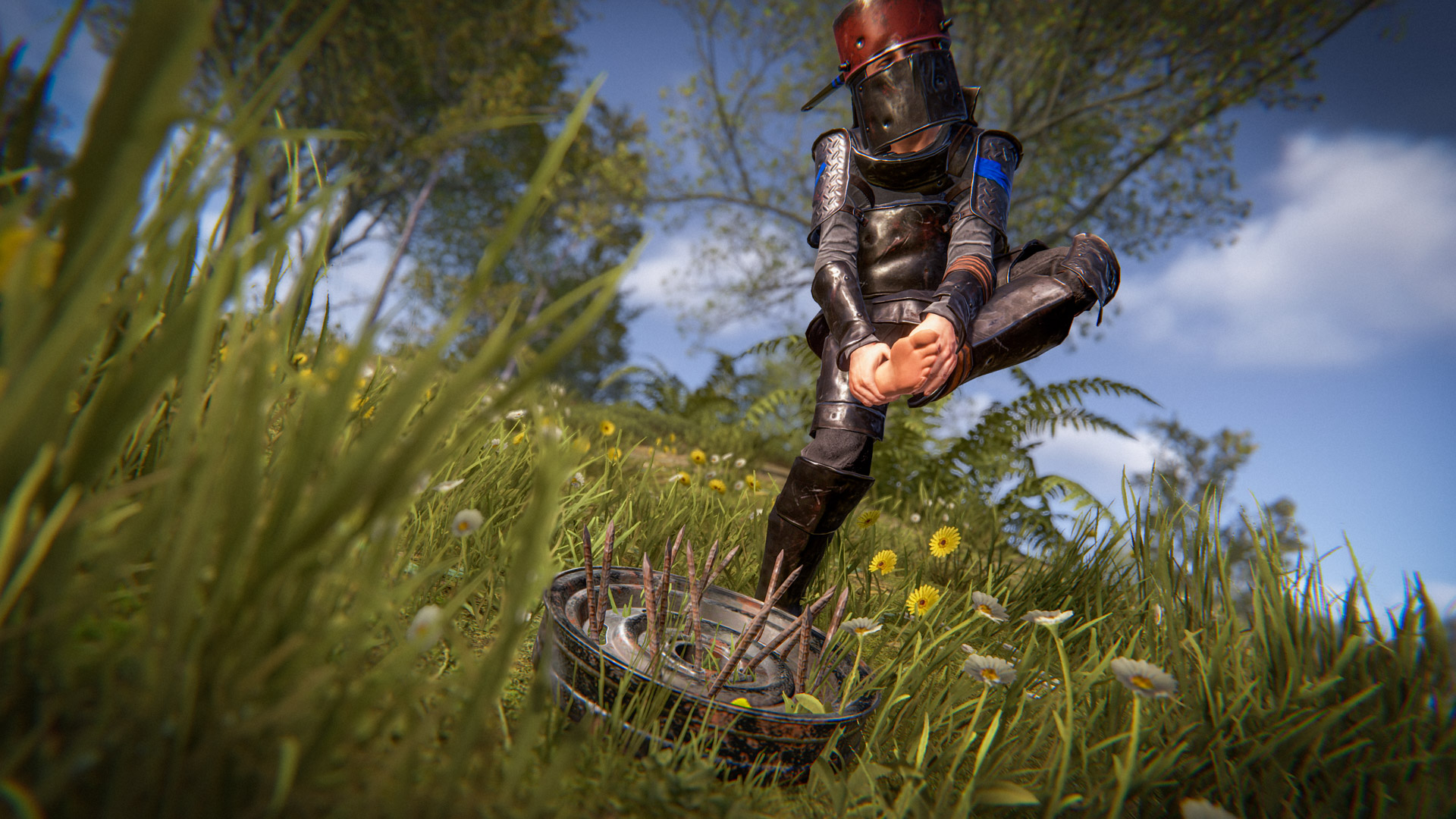 A man wearing makeshift armour and a bucket helmet clutches his foot in pain after stepping on a car wheel with rusty nails protruding from it.