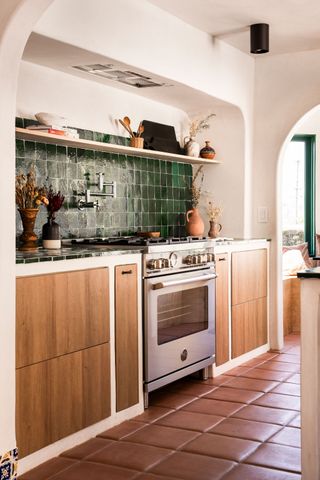 A Spanish-style kitchen with terracotta-red flooring