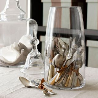 glass jar with spoons and tableware