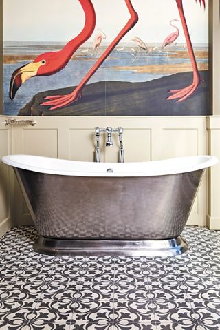 freestanding bath with wall mural and patterned victorian tiles