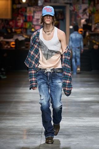 Man in tucker cap, vest and camisole on DSquared2 runway