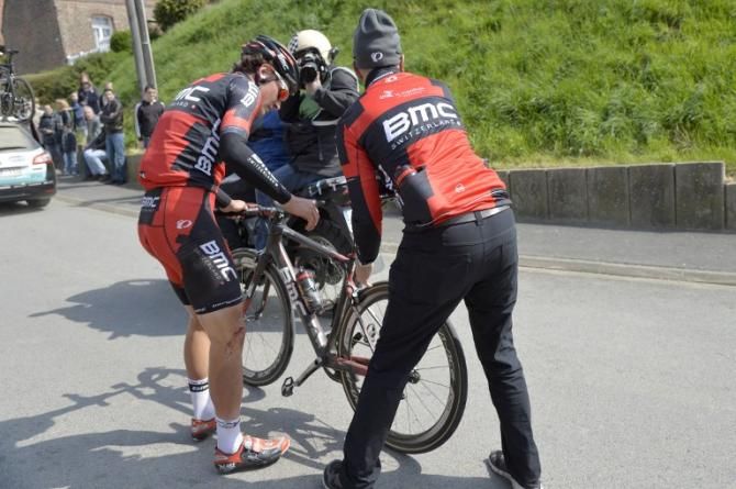 Switzerland's Silvan Dillier (BMC) is helped by a team assistant after he fell