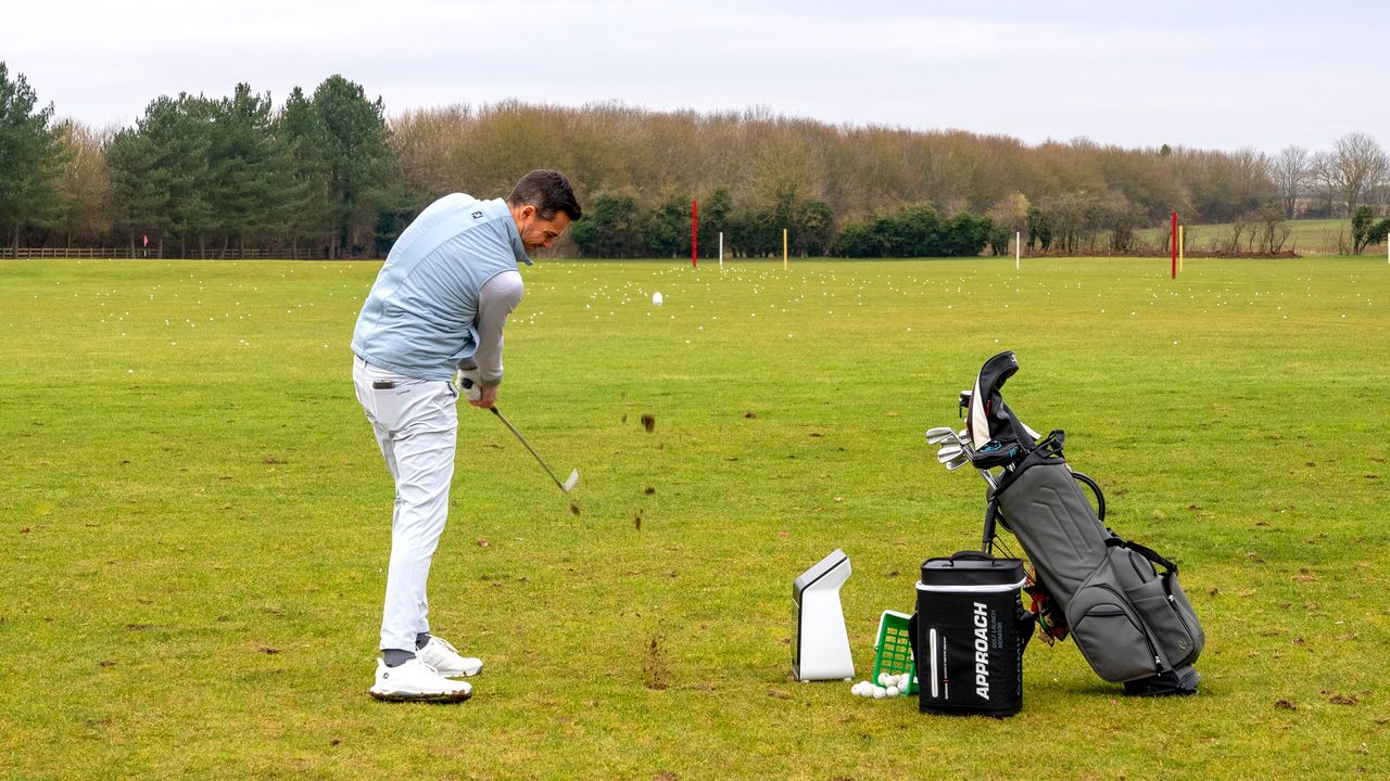 Golfer hitting a ball on the R50 launch monitor