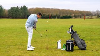 Golfer hitting a ball on the R50 launch monitor